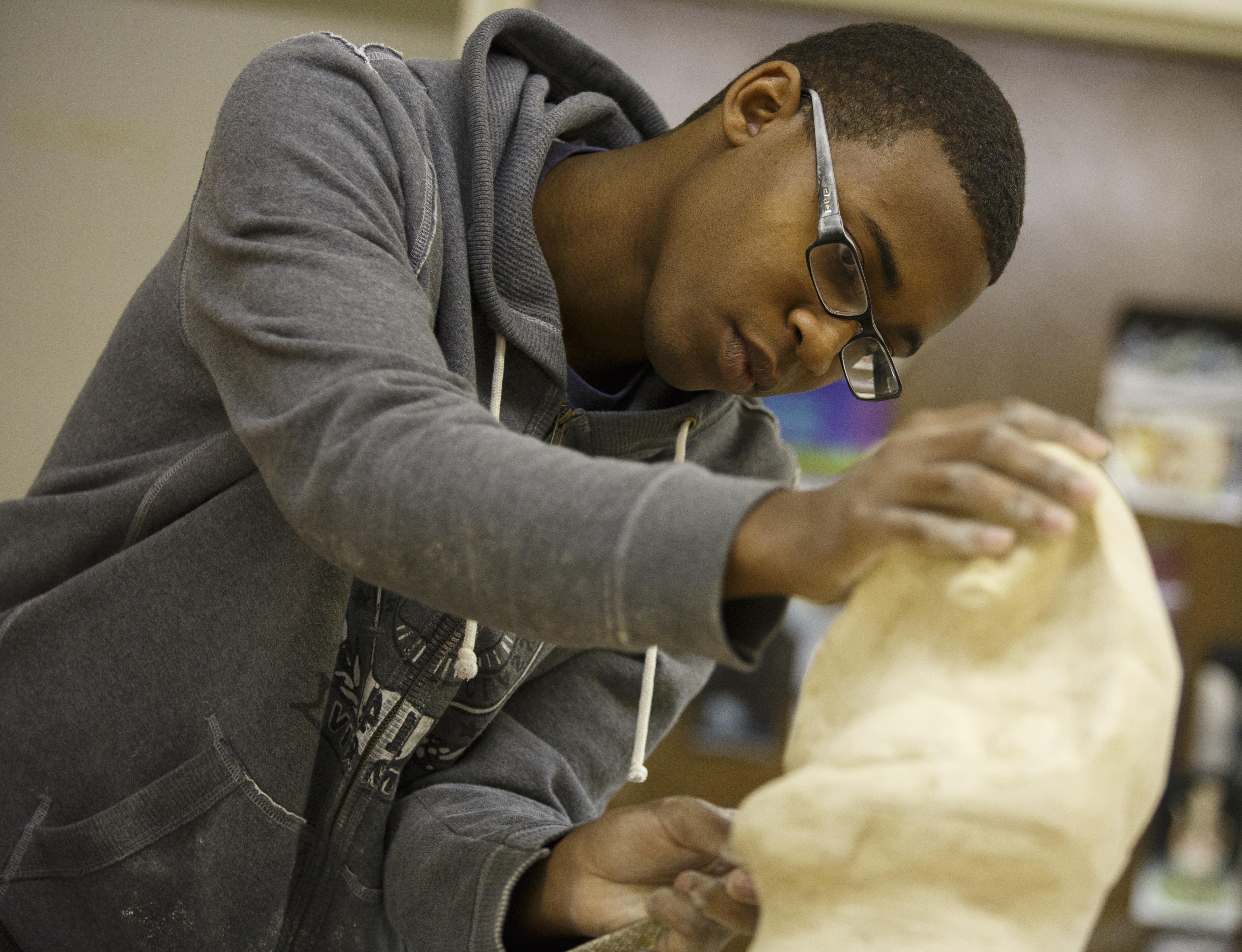 Student sanding his sculpture